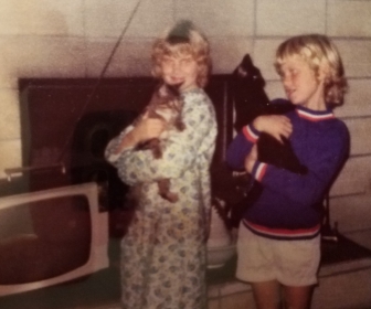 Trish and I with our first cats. She had Kiggy, a male Tabby who ran away in his prime. I held Midnight, who birthed loads of kittens in her lifetime.